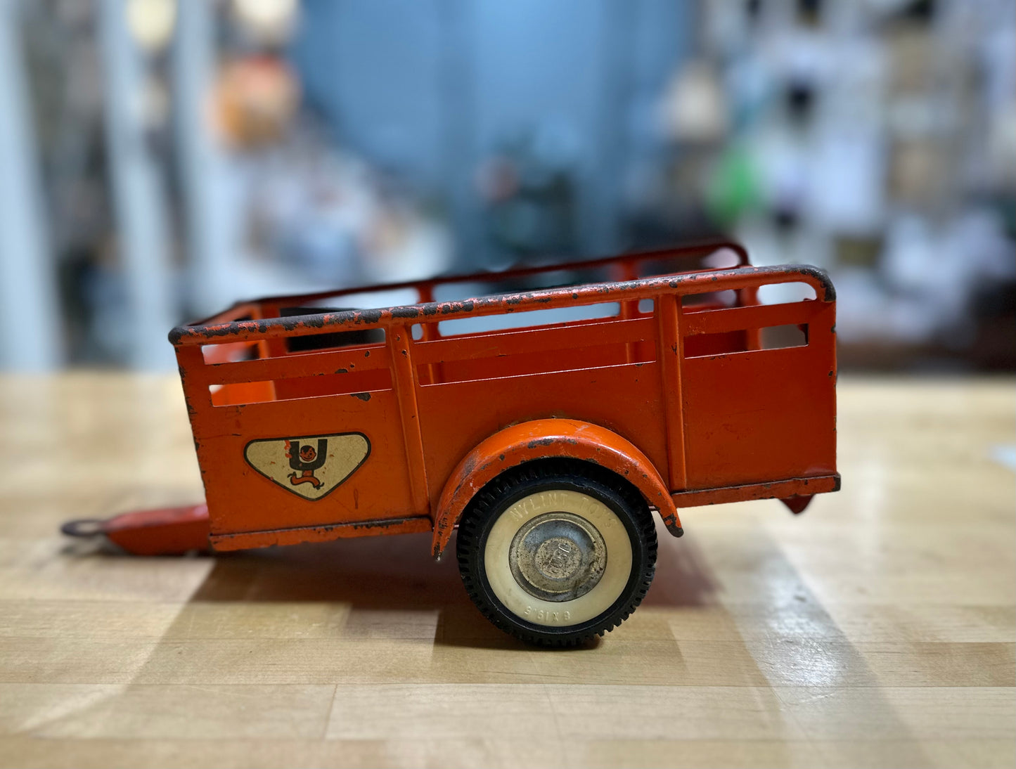 Side view of vintage U-Haul open trailer toy with realistic detailing