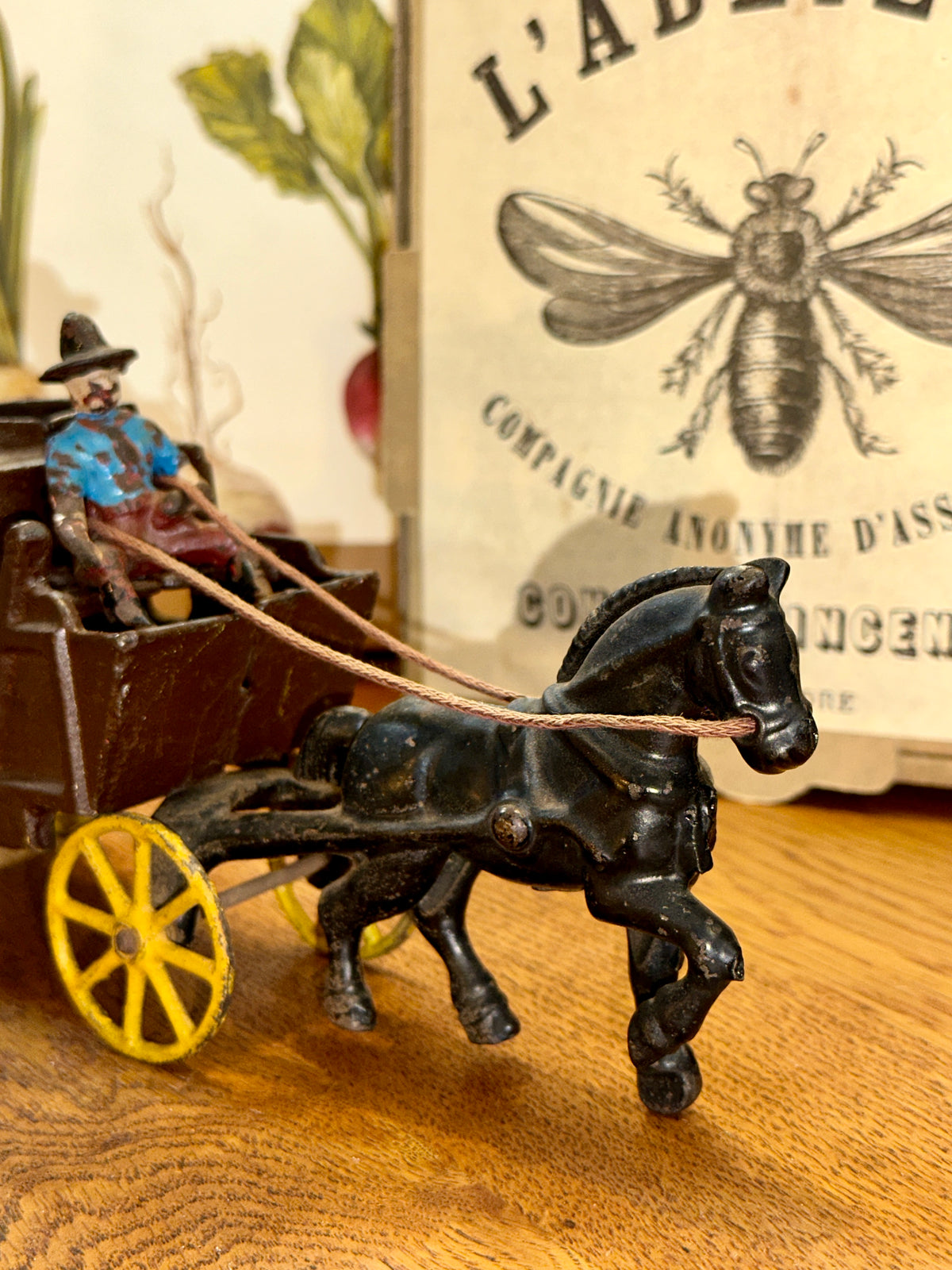 Close-up of cowboy driver wearing a blue shirt and hat on a cast iron stagecoach