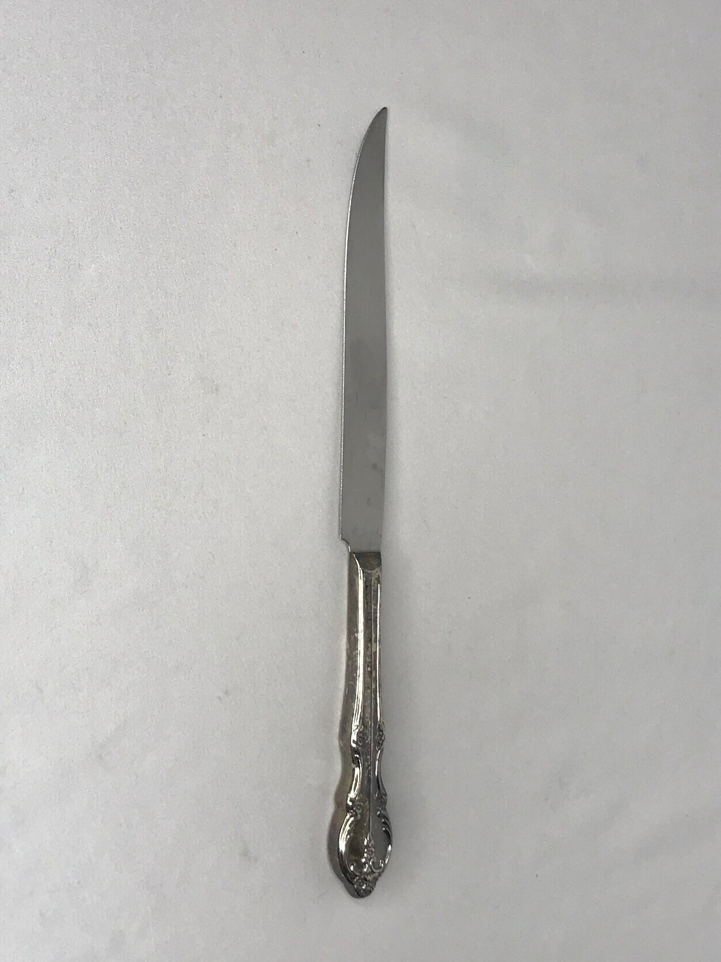 Aged silver plated Hallow knife 10-3/8" scrolls w/flower design