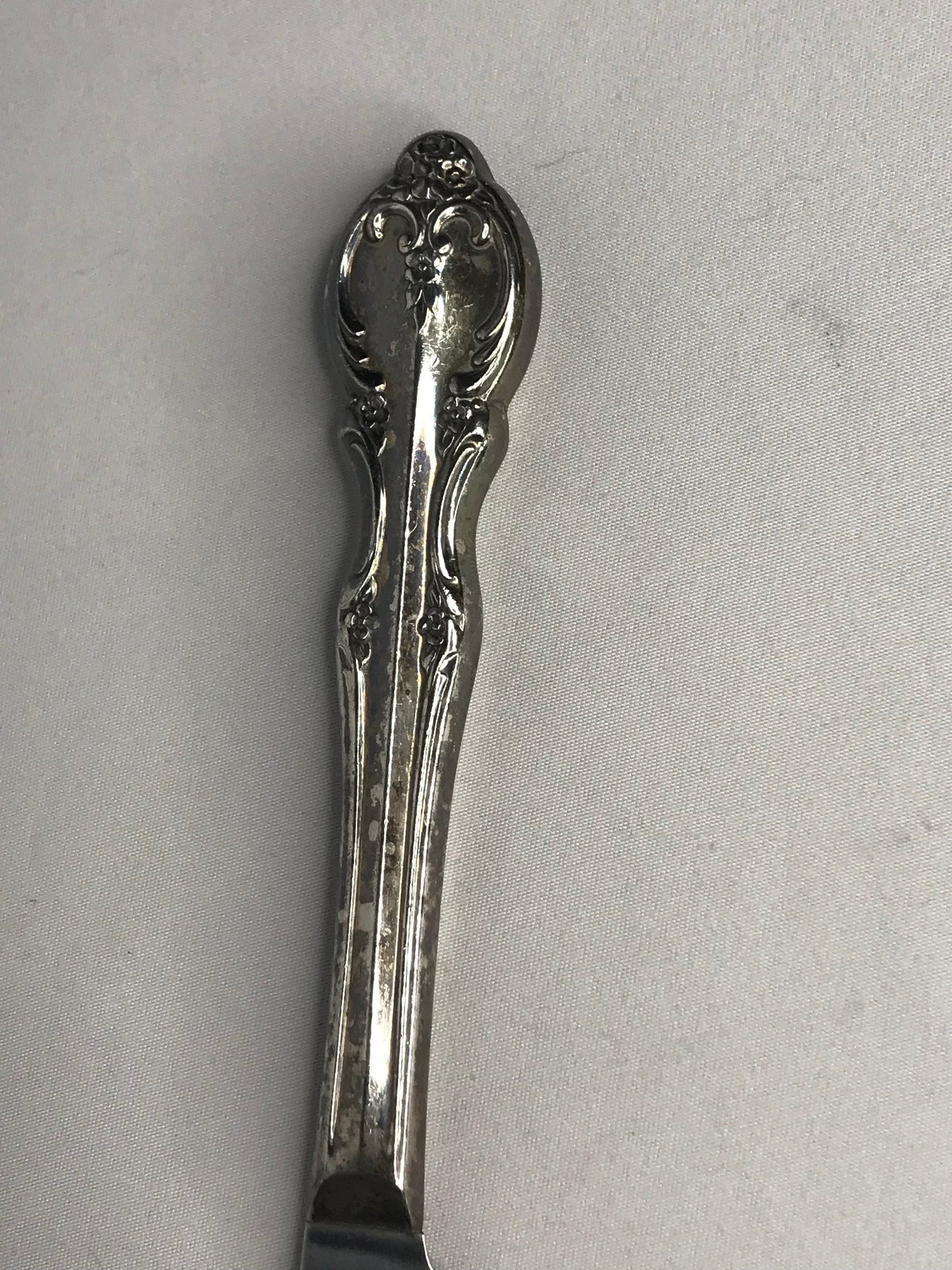Aged silver plated Hallow knife 10-3/8" scrolls w/flower design