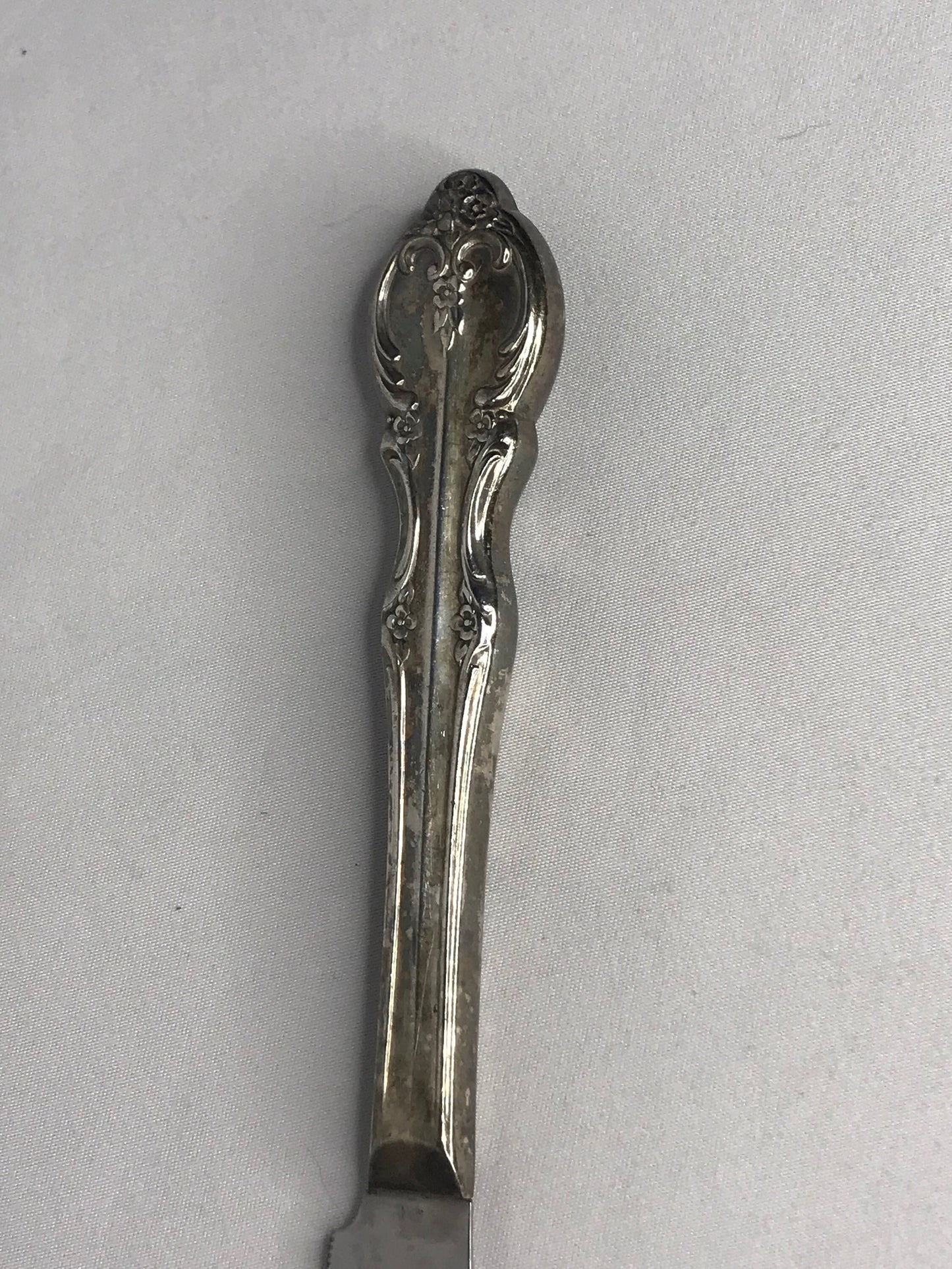 Aged silver plated Hallow knife 10-3/8" scrolls w/flower design