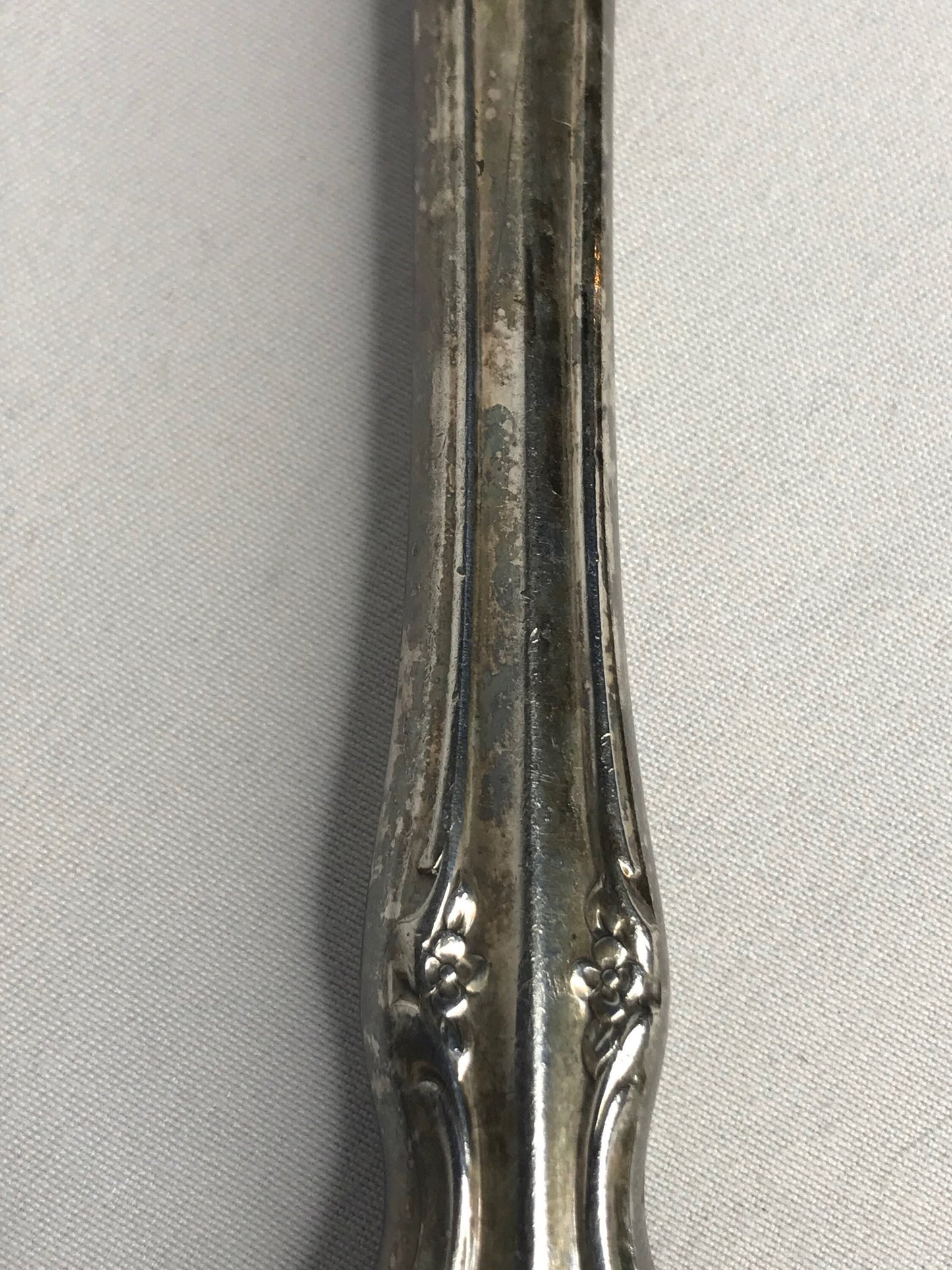 Aged silver plated Hallow knife 10-3/8" scrolls w/flower design