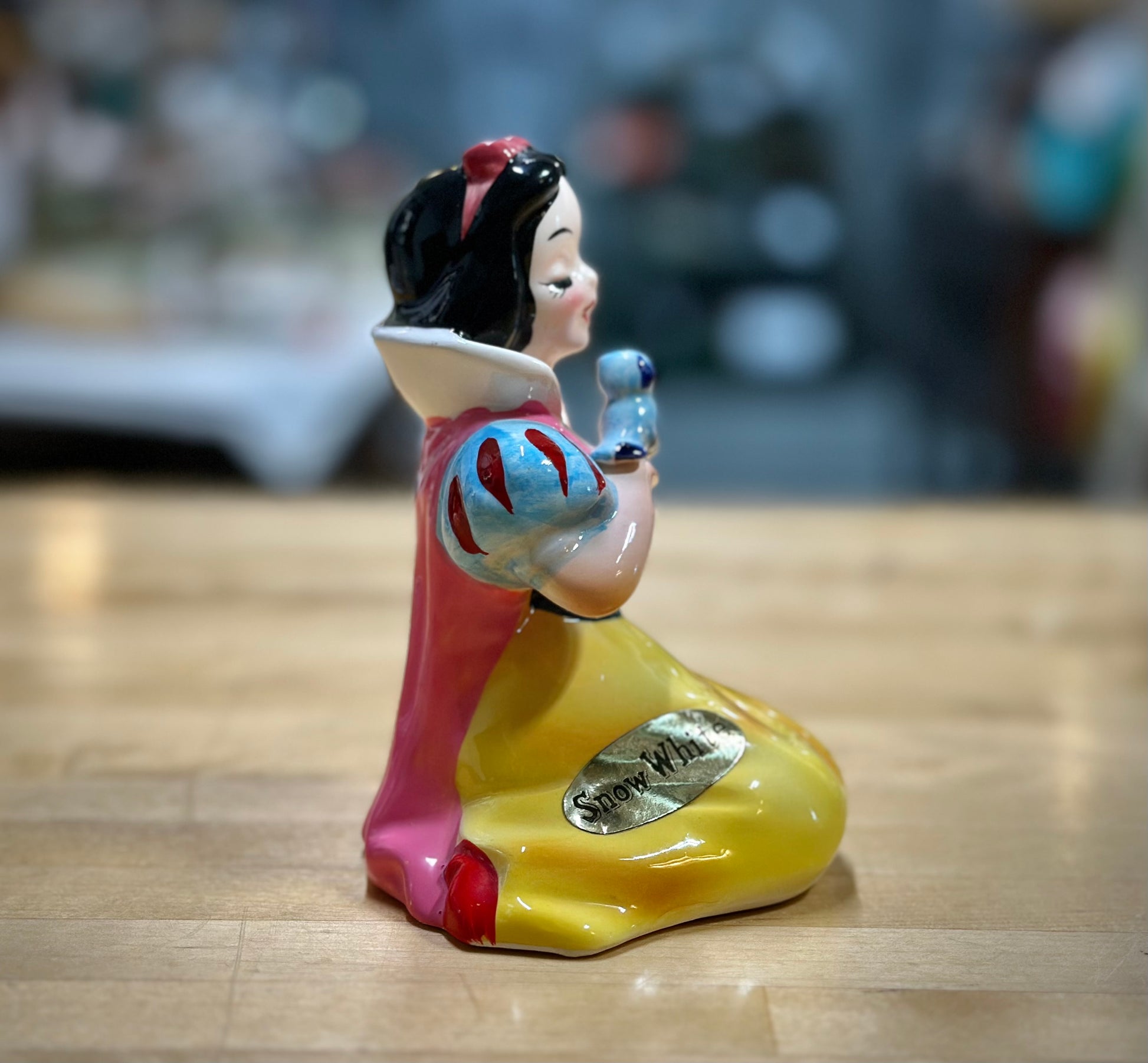 Side facing ceramic Snow White figurine