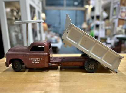 Side view of vintage Structo Ride-er Dumper Toy Truck without seat