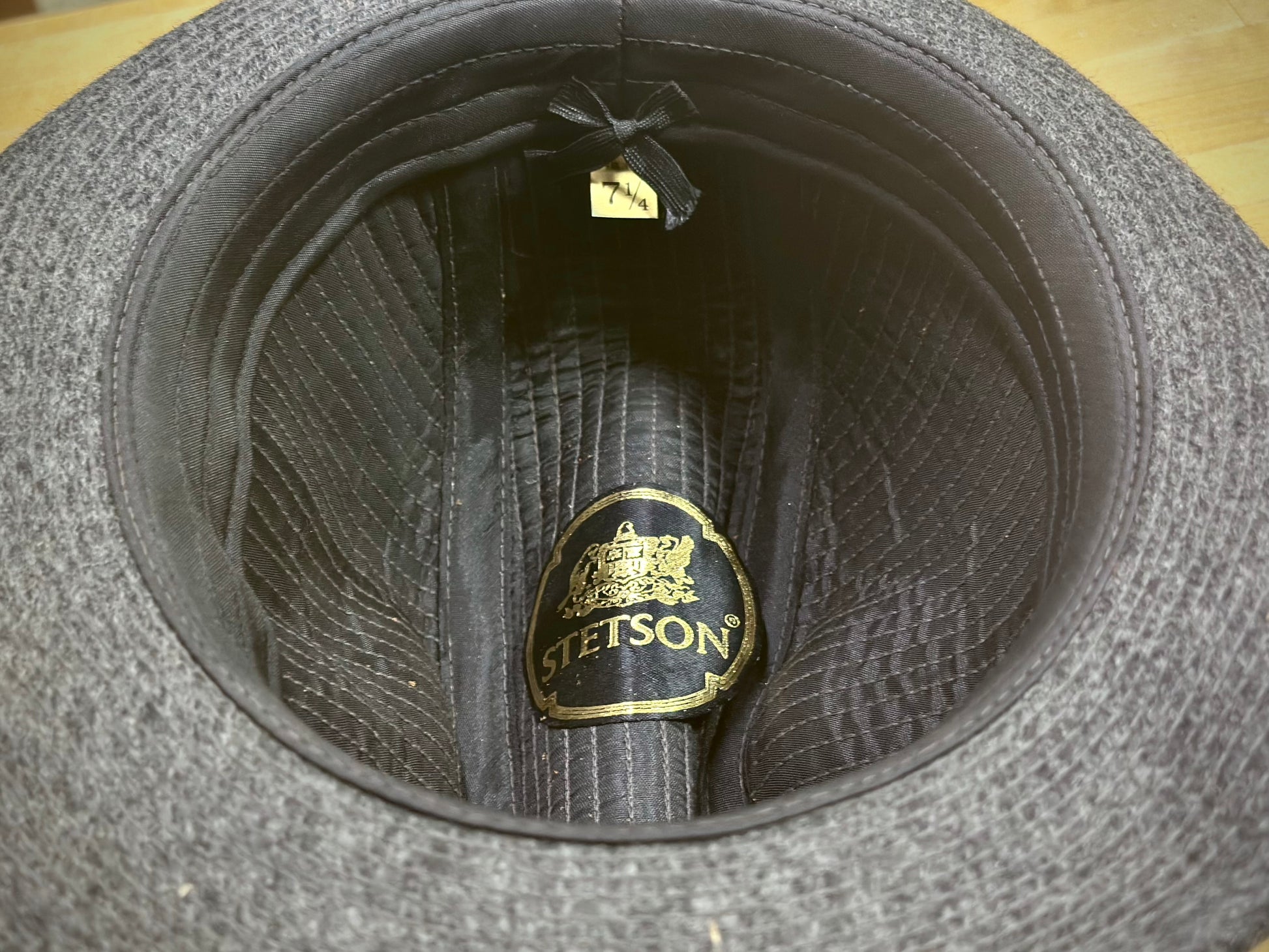 Gray hat interior with a visible brand label on a wooden surface