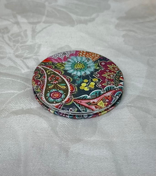 Floral compact mirror closed with intricate flower design