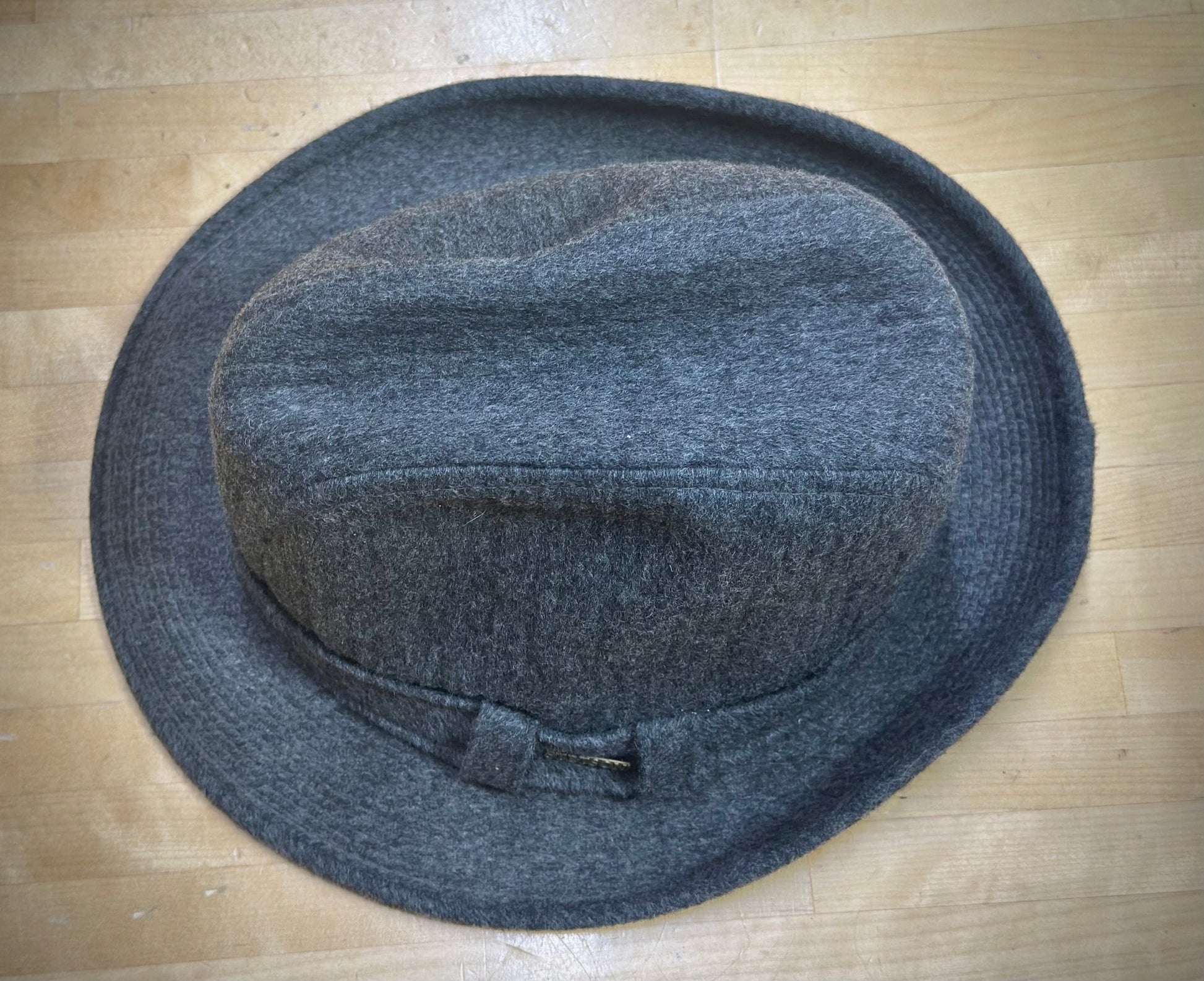 Gray felt hat on a wooden surface