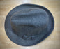 Gray felt hat on a wooden surface