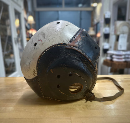 Side view of Vintage football helmet on a wooden surface