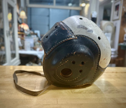 Side view of Vintage football helmet on a wooden surface