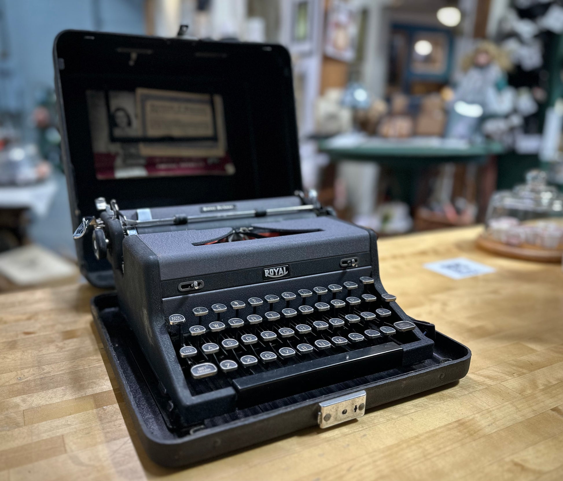 Vintage Royal typewriter on a wooden table with a blurred background