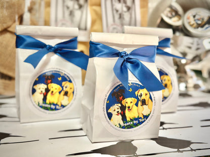 Treats by Tori blueberry dog treat gift bags displayed with blue satin bows