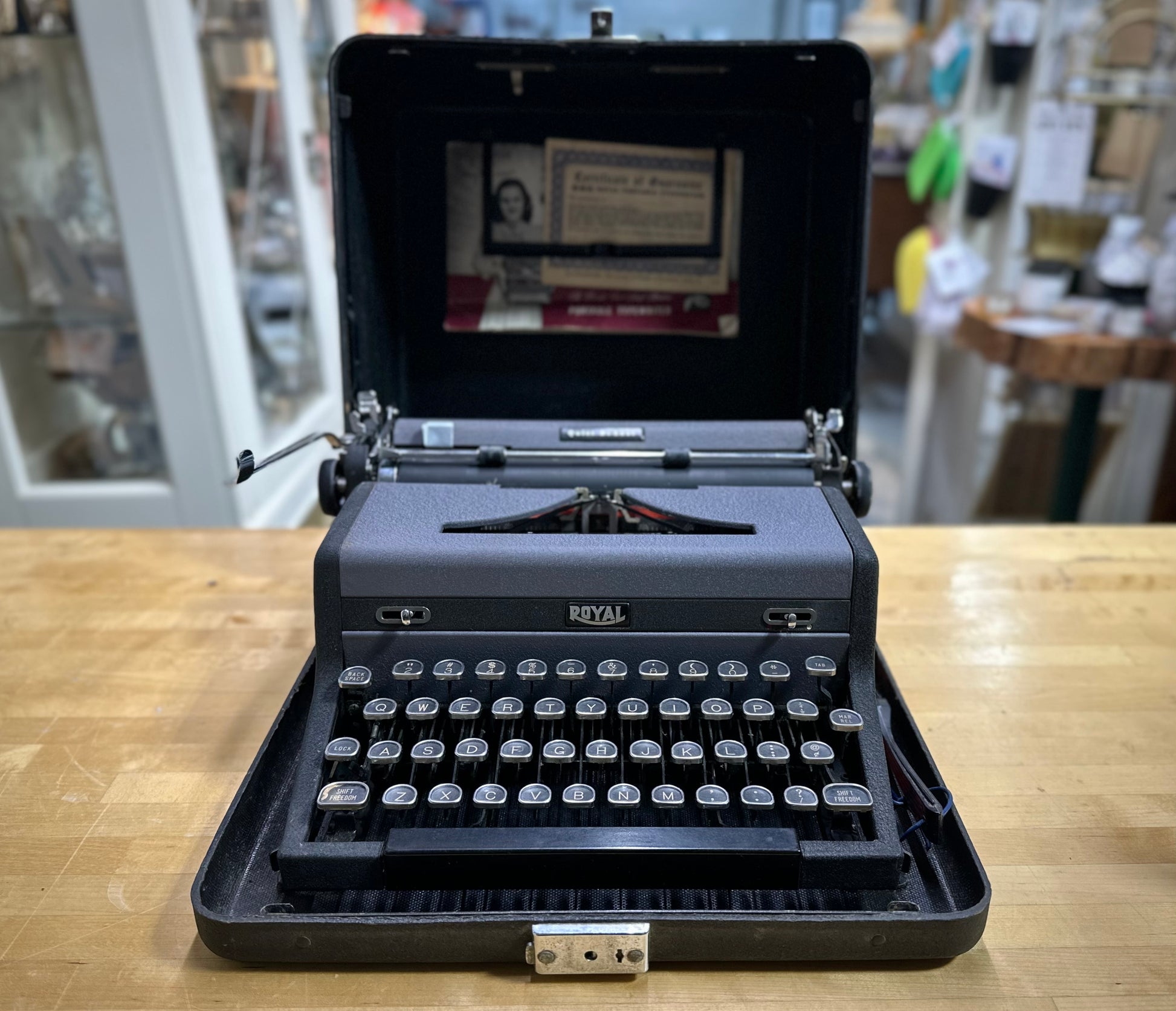 Vintage Royal typewriter on a wooden table with a blurred background