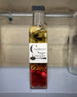 Cranberry sage vinegar bottle with fresh cranberries and sage leaves from farm