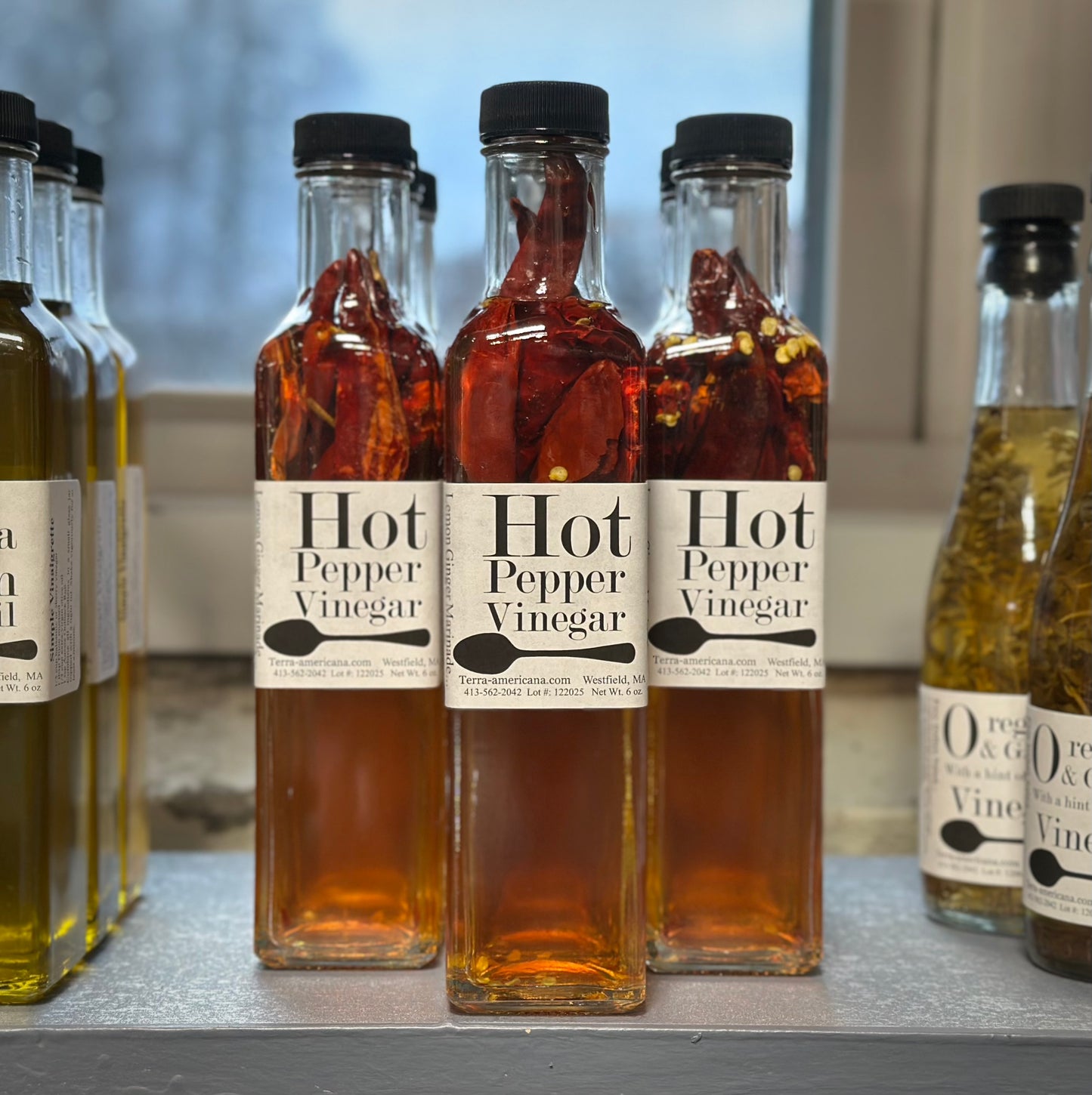 Hot pepper vinegar in mini wine bottle - fresh hot peppers in apple cider vinegar from Terra Americana