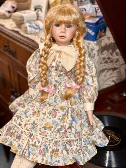Vintage Porcelain Doll with Blonde Braids and Floral Dress
