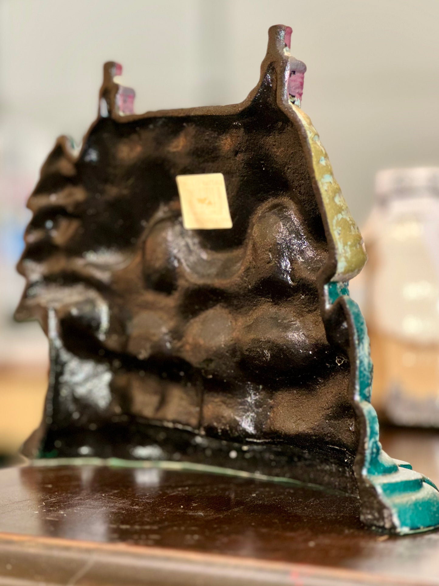 Vintage rustic cast iron door holder with thatched roof
