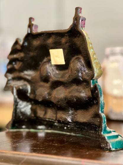 Vintage rustic cast iron door holder with thatched roof
