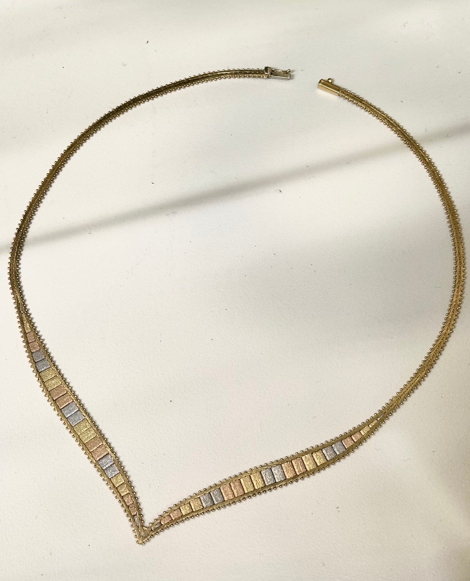 Necklace with gold and silver beads on a light background