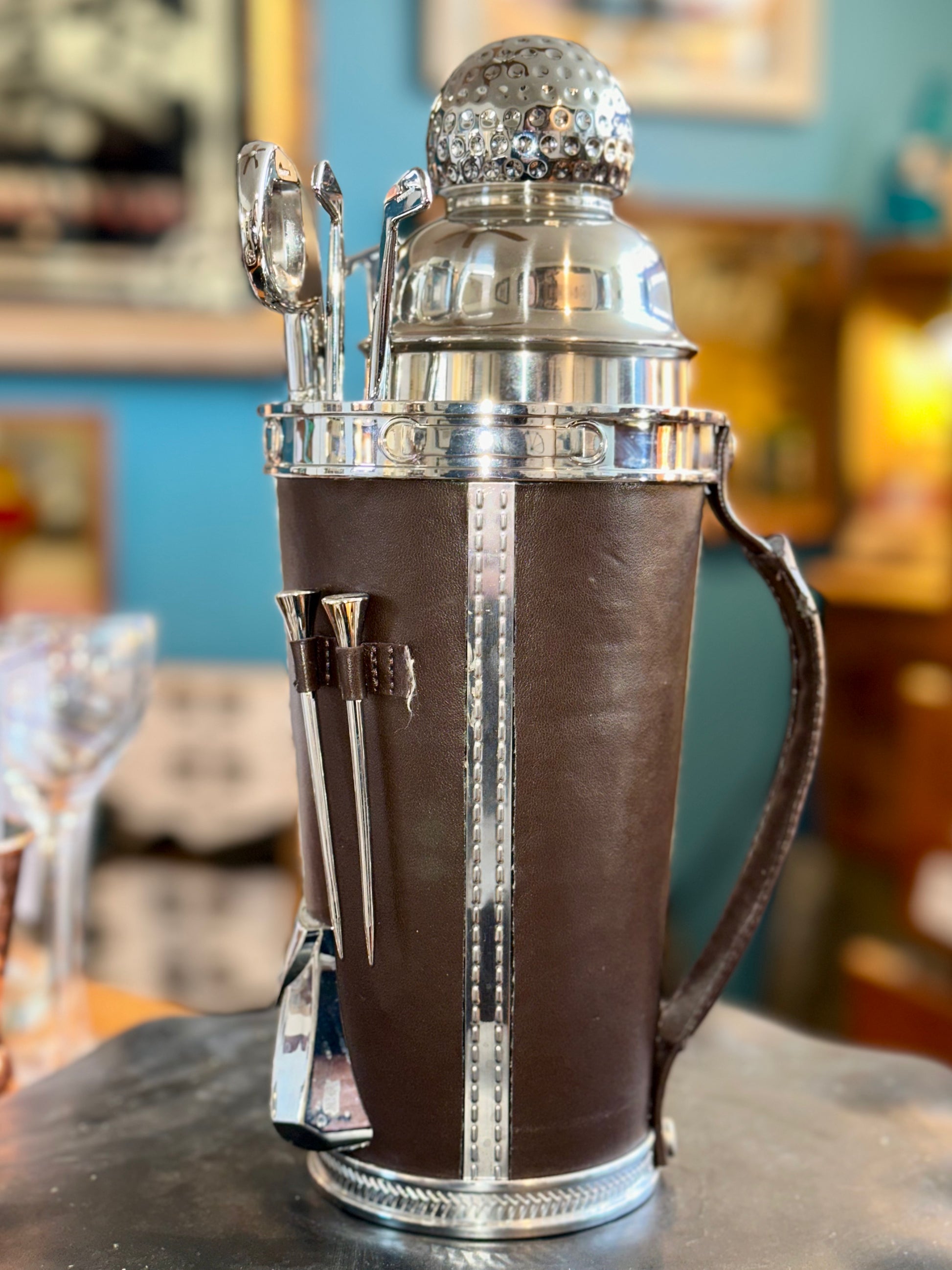 Side view of vintage golf bag cocktail shaker set showing handle and bar tools