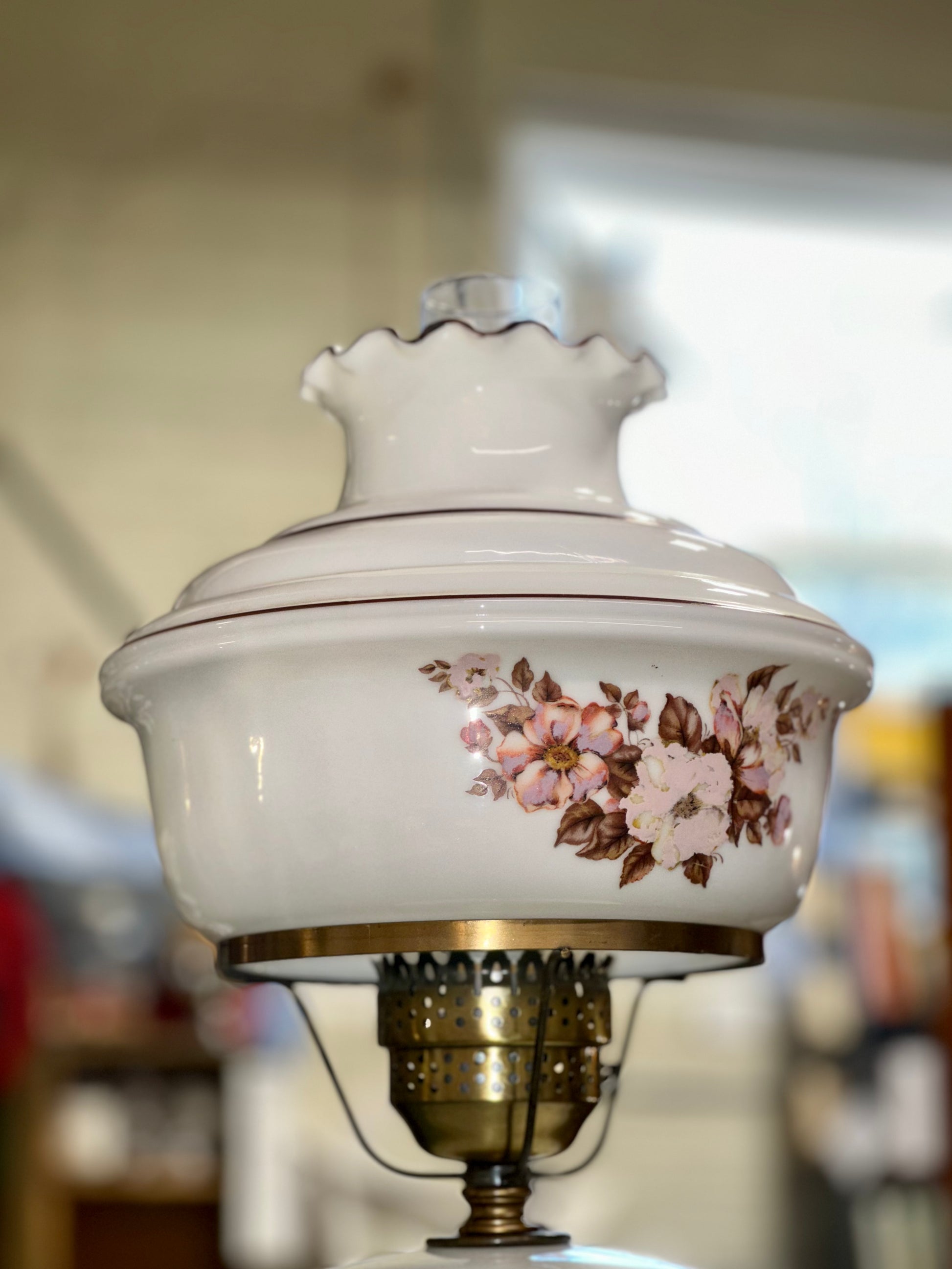 Antique style milk glass lamp with pink flowers and scalloped top shade