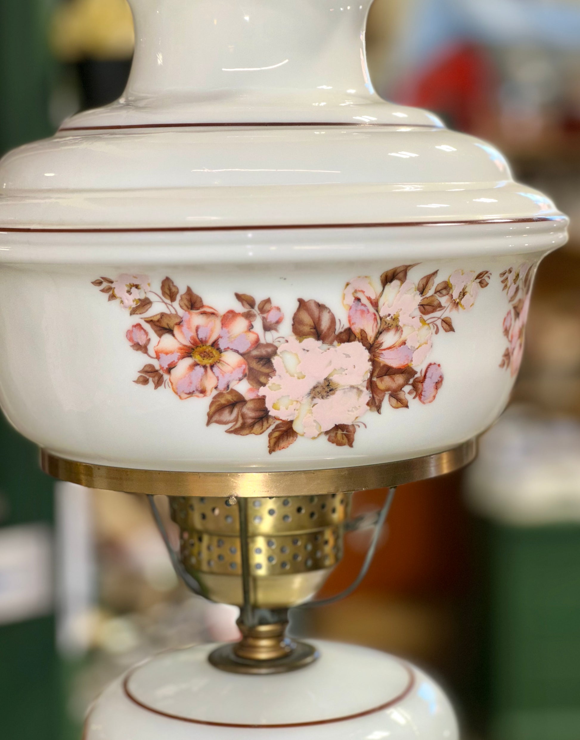 Close up of hand painted floral milk glass lamp with ruffled edge shade