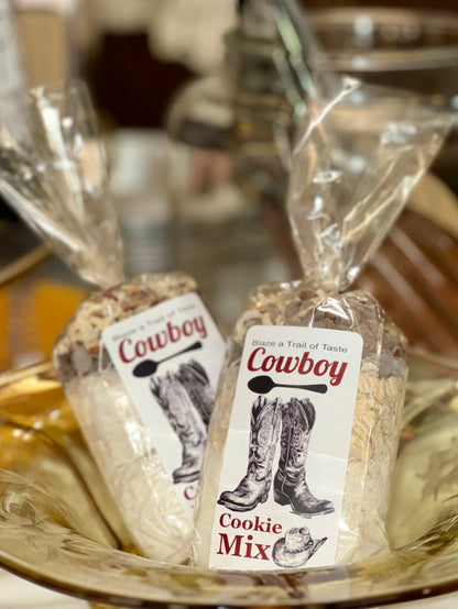 Two packages of cowboy-themed cookie mix on a decorative plate.