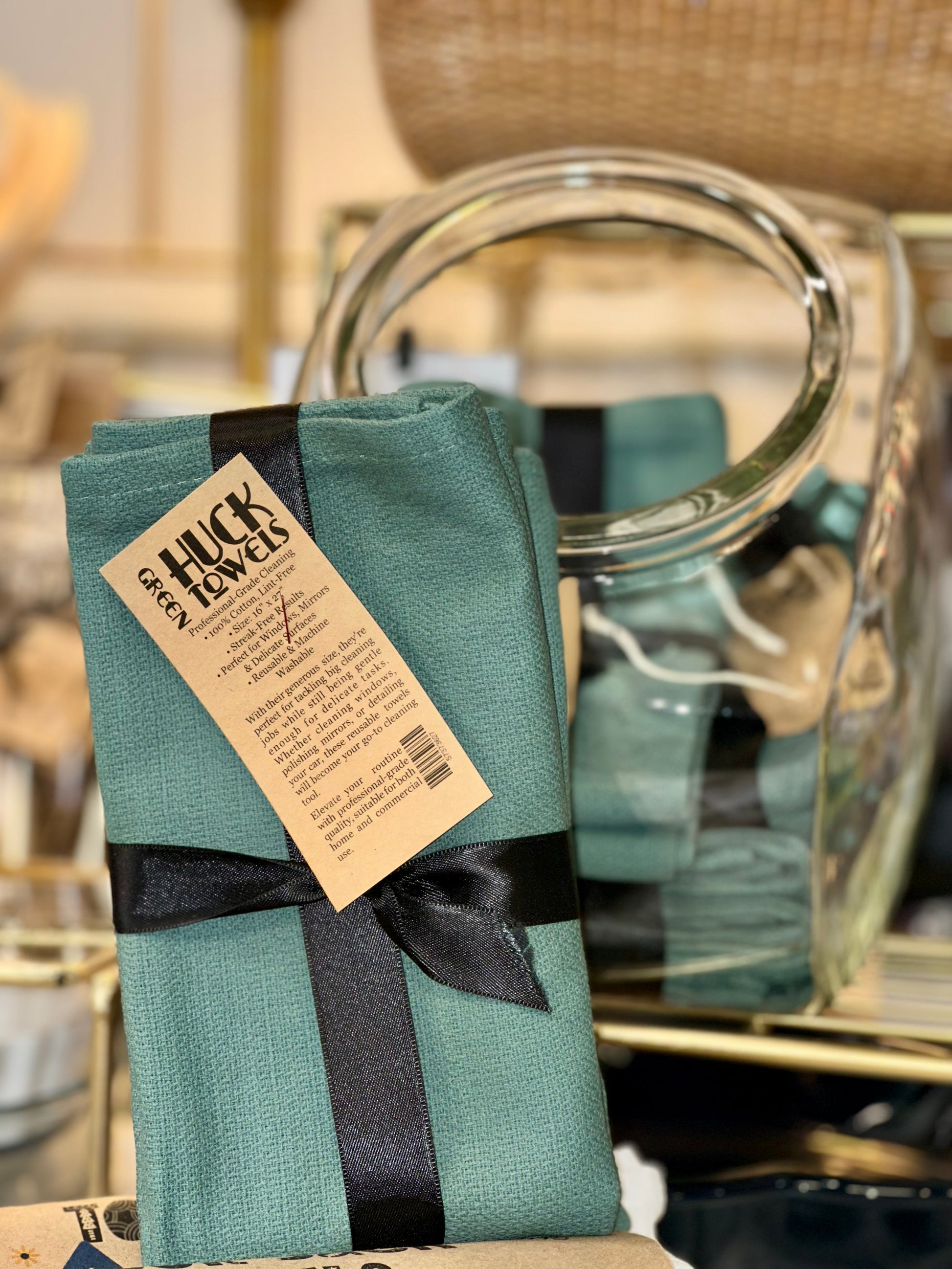 Green Huck towels with a black ribbon displayed 
