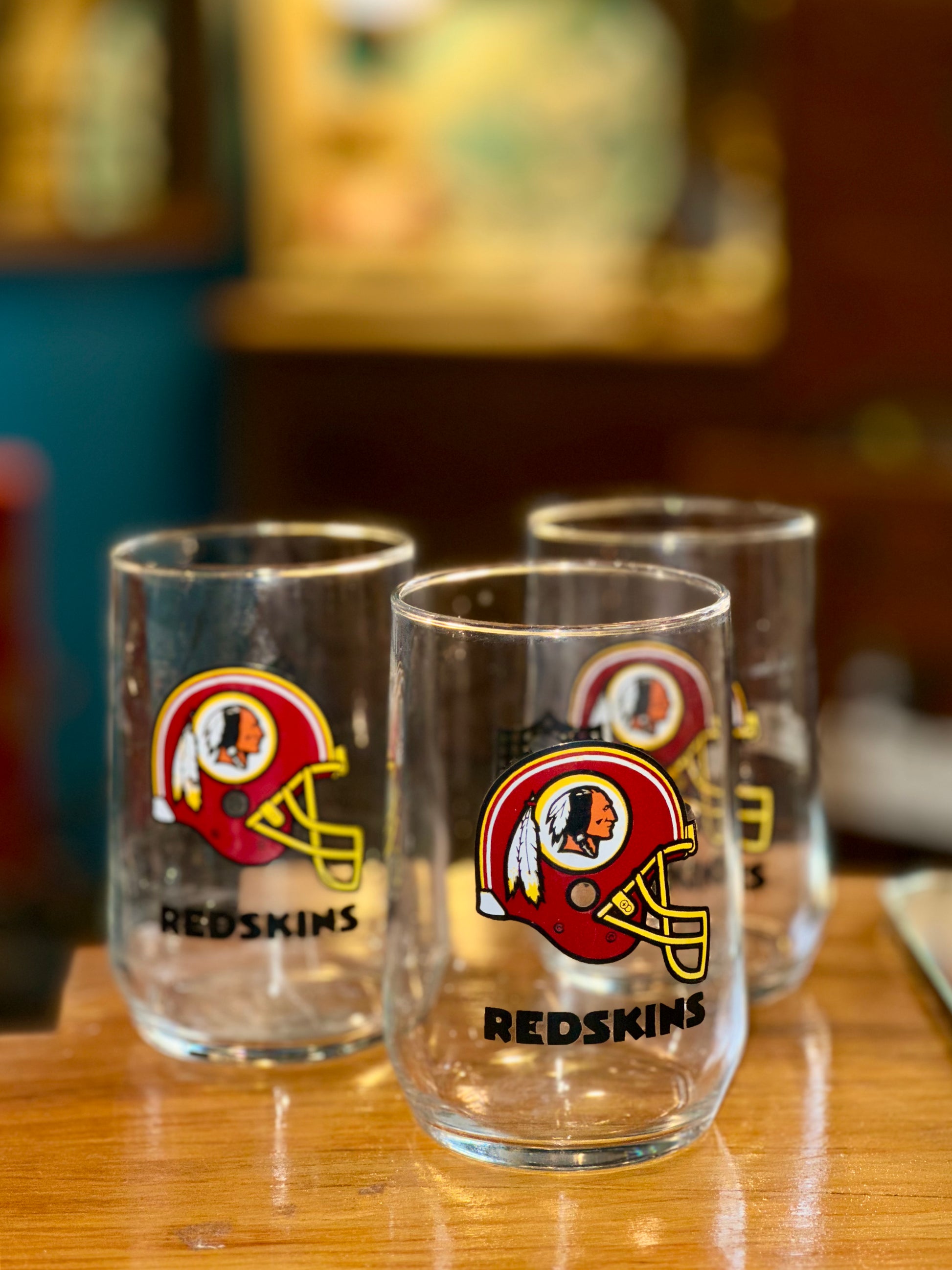 Vintage NFL Redskins football glasses on wooden table
