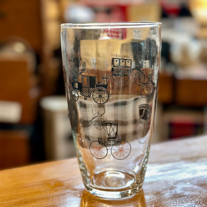 Retro whiskey tumbler featuring antique horse-drawn carriages