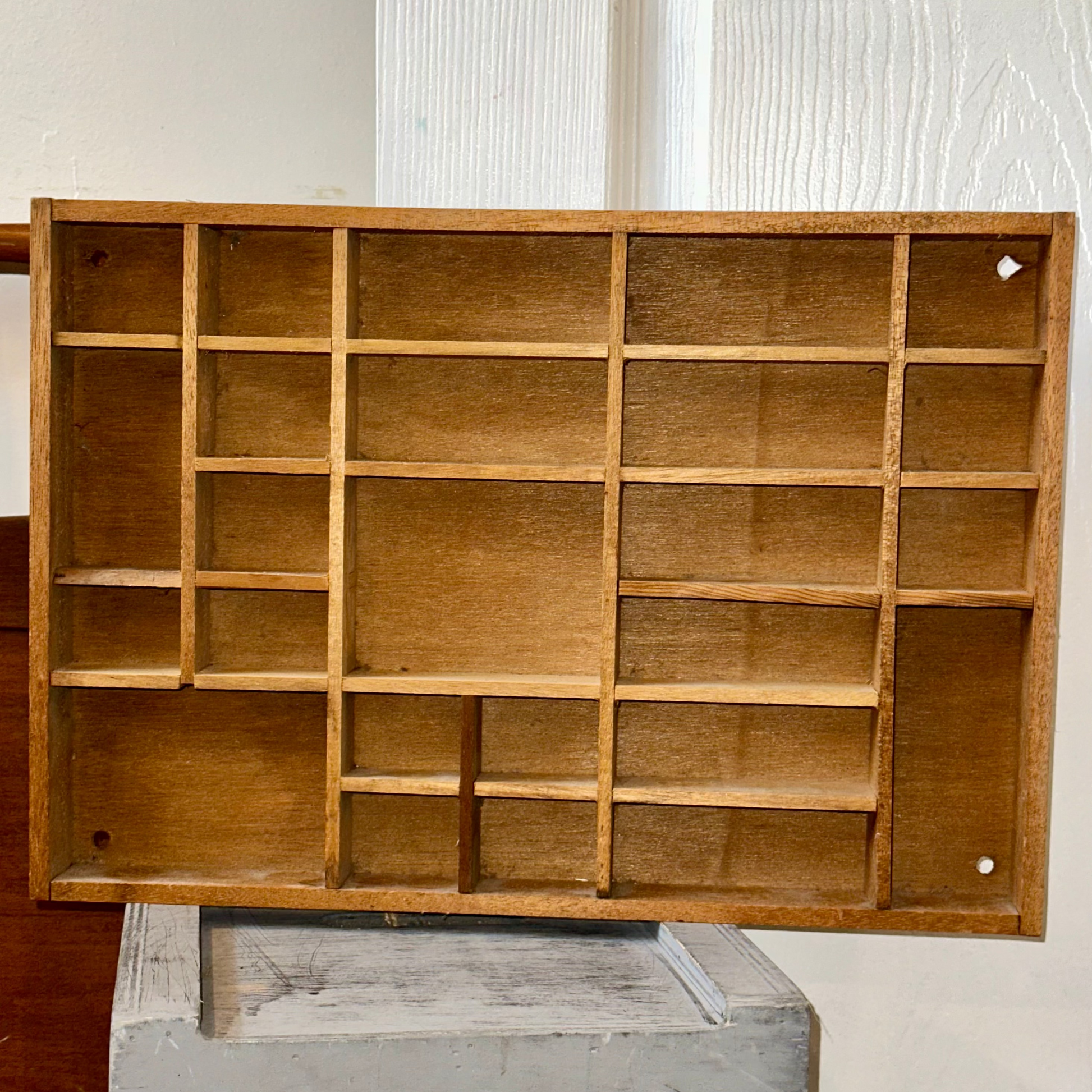 Vintage wooden printer’s tray with multiple compartments for collectibles and miniatures