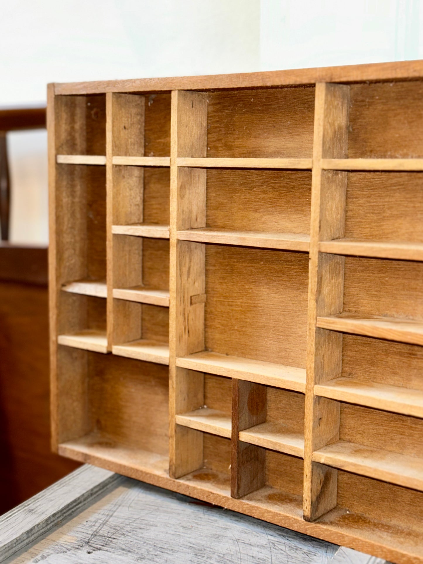 Collection of vintage wooden display cases featuring printer’s trays and compartment organizers for collectibles