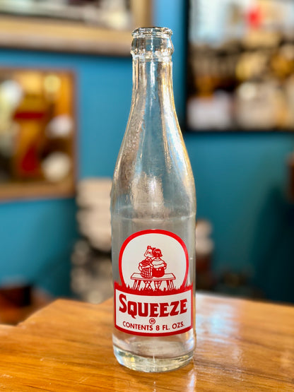 Vintage Squeeze 8 ounce clear glass soda bottle