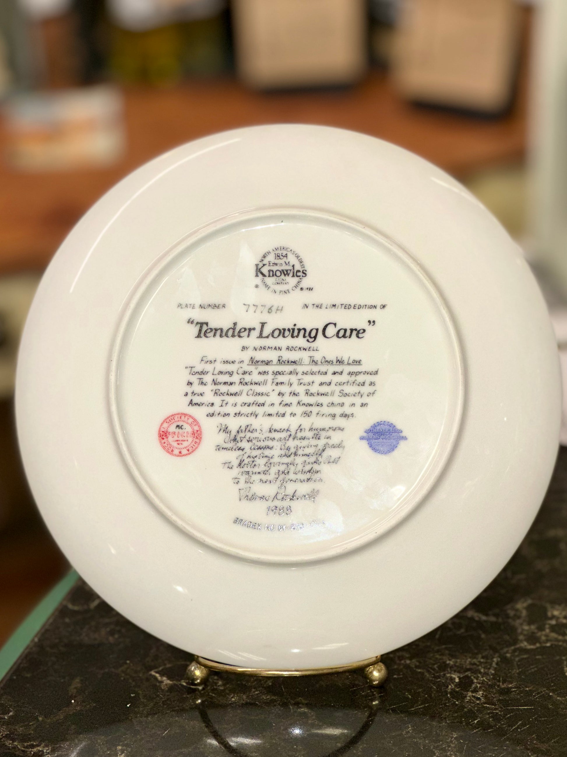 Back of Norman Rockwell Tender Loving Care Knowles collector plate showing edition number 7776H and Bradex mark