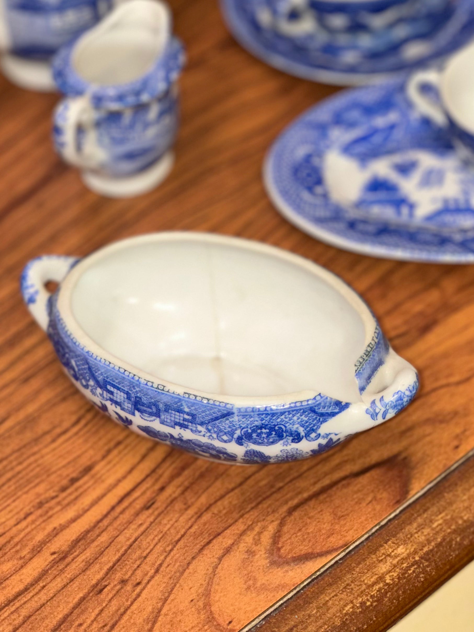 Blue Willow porcelain serving bowl with visible vintage crack