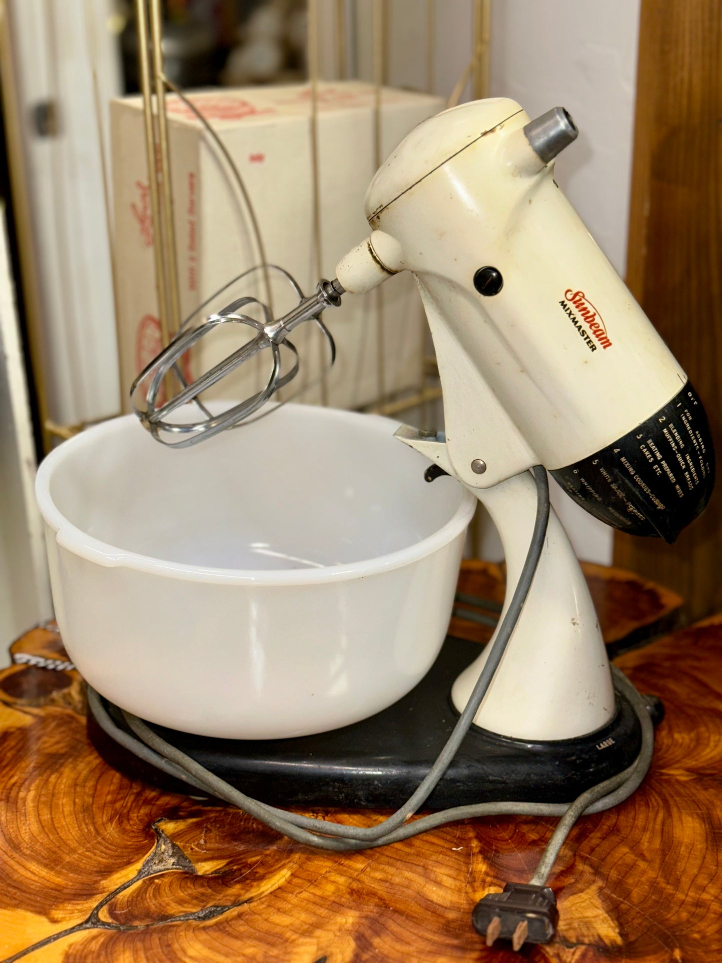 Collectible Sunbeam stand mixer with milk glass bowls and vintage accessories