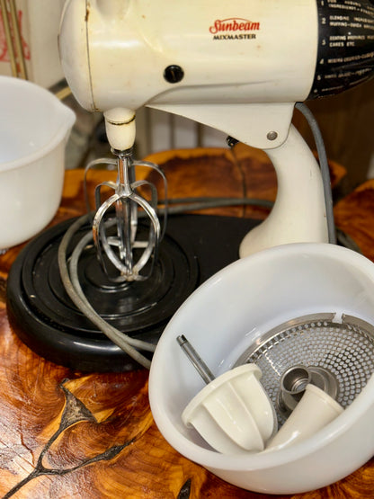 1950s Sunbeam Mixmaster mixer displayed with original attachments and bowls