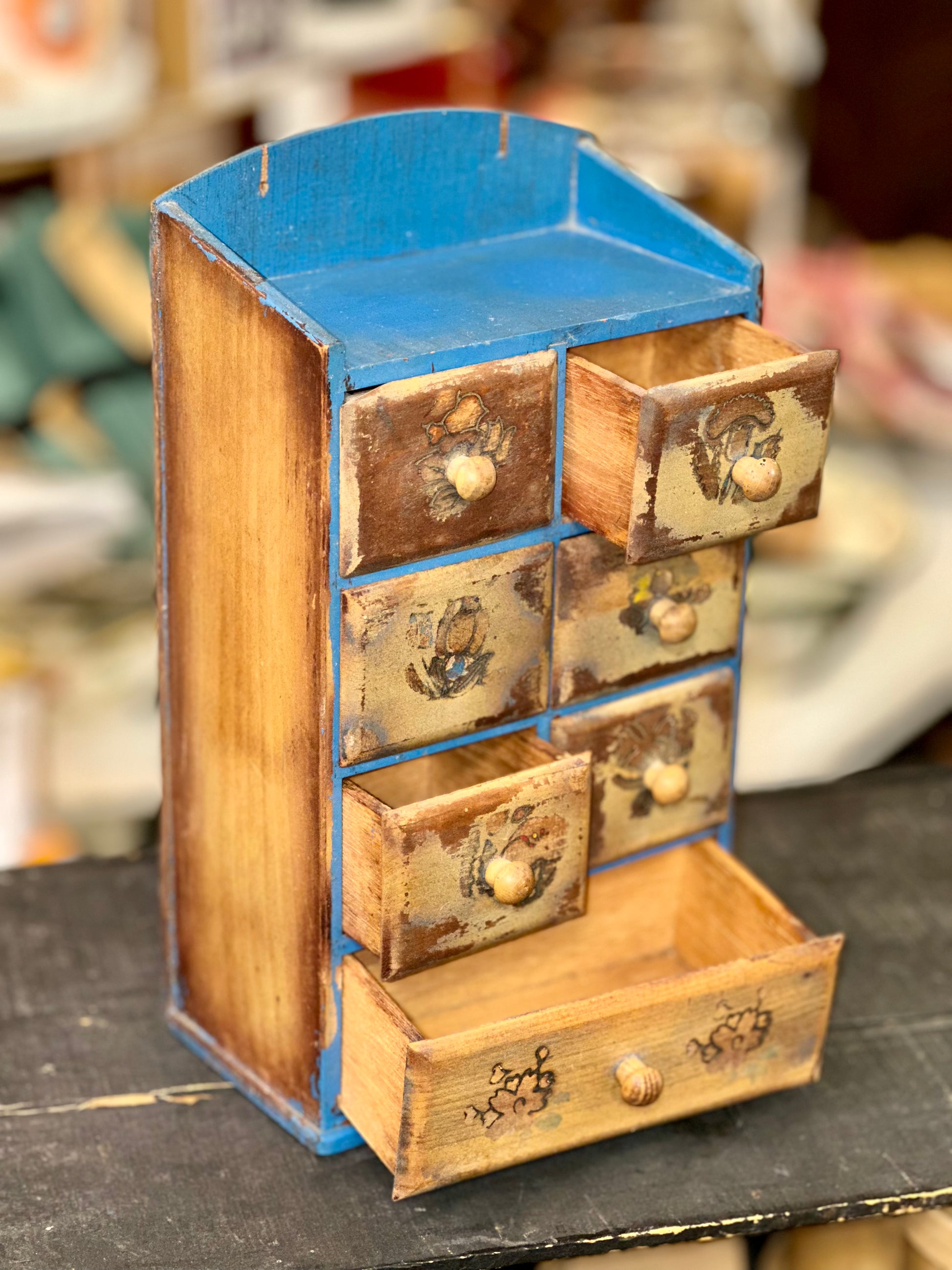 Hand-painted wooden apothecary cabinet with multiple storage compartments