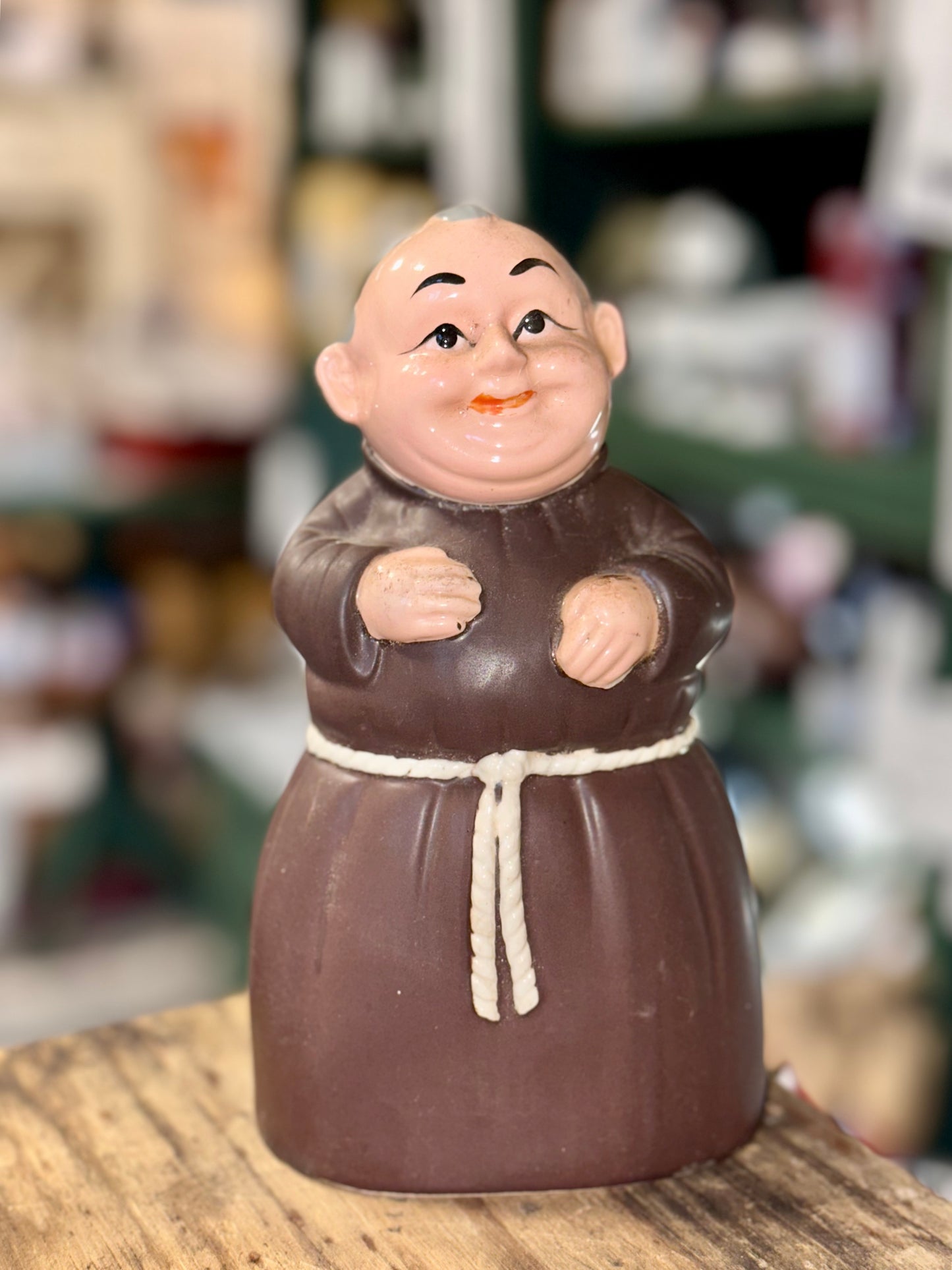Smiling friar piggy bank with hand-painted facial details.