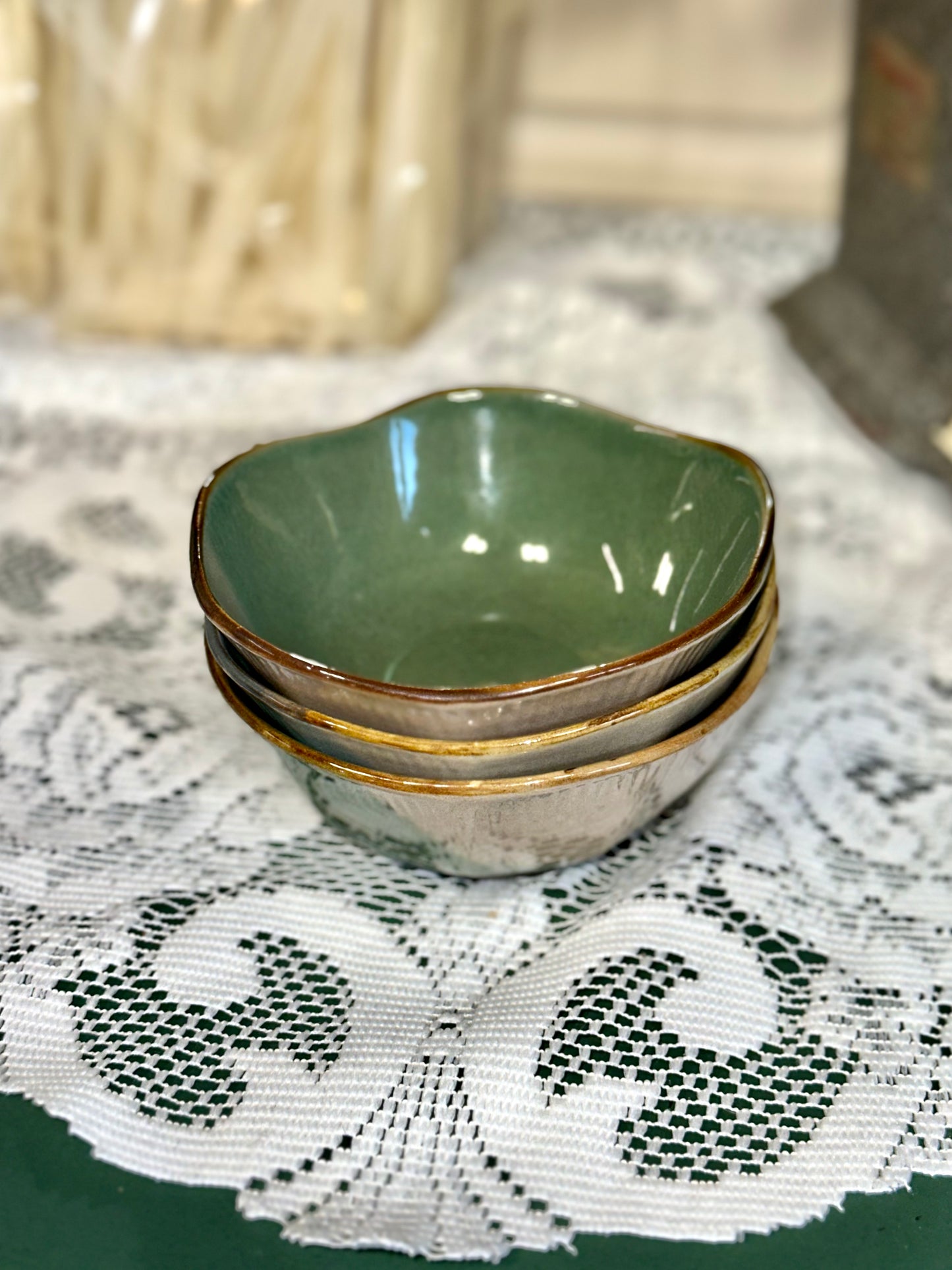 Green and blue stoneware dessert bowls with hand-painted botanical motif.