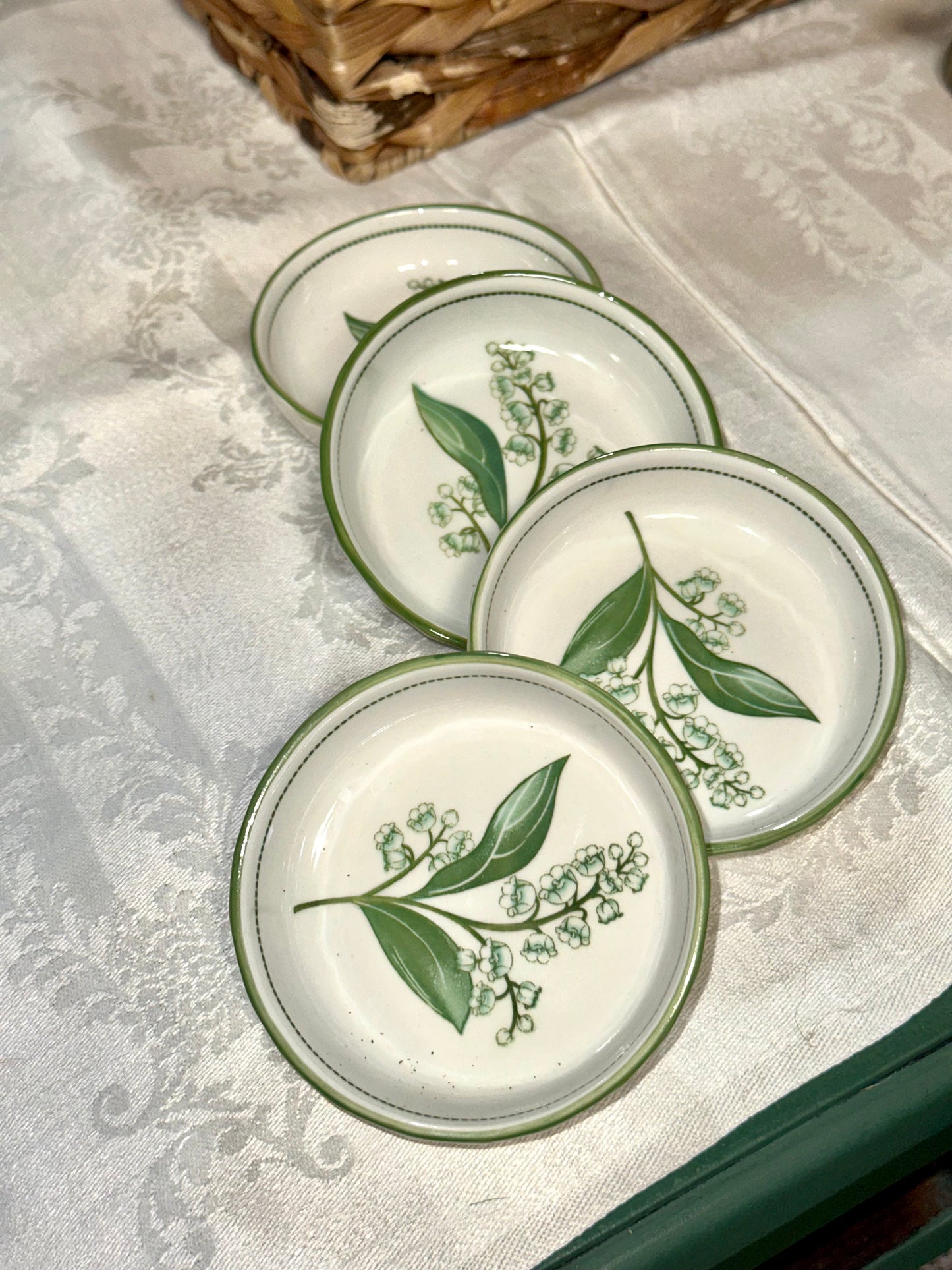 Set of four vintage Lily of the Valley ceramic dessert bowls.