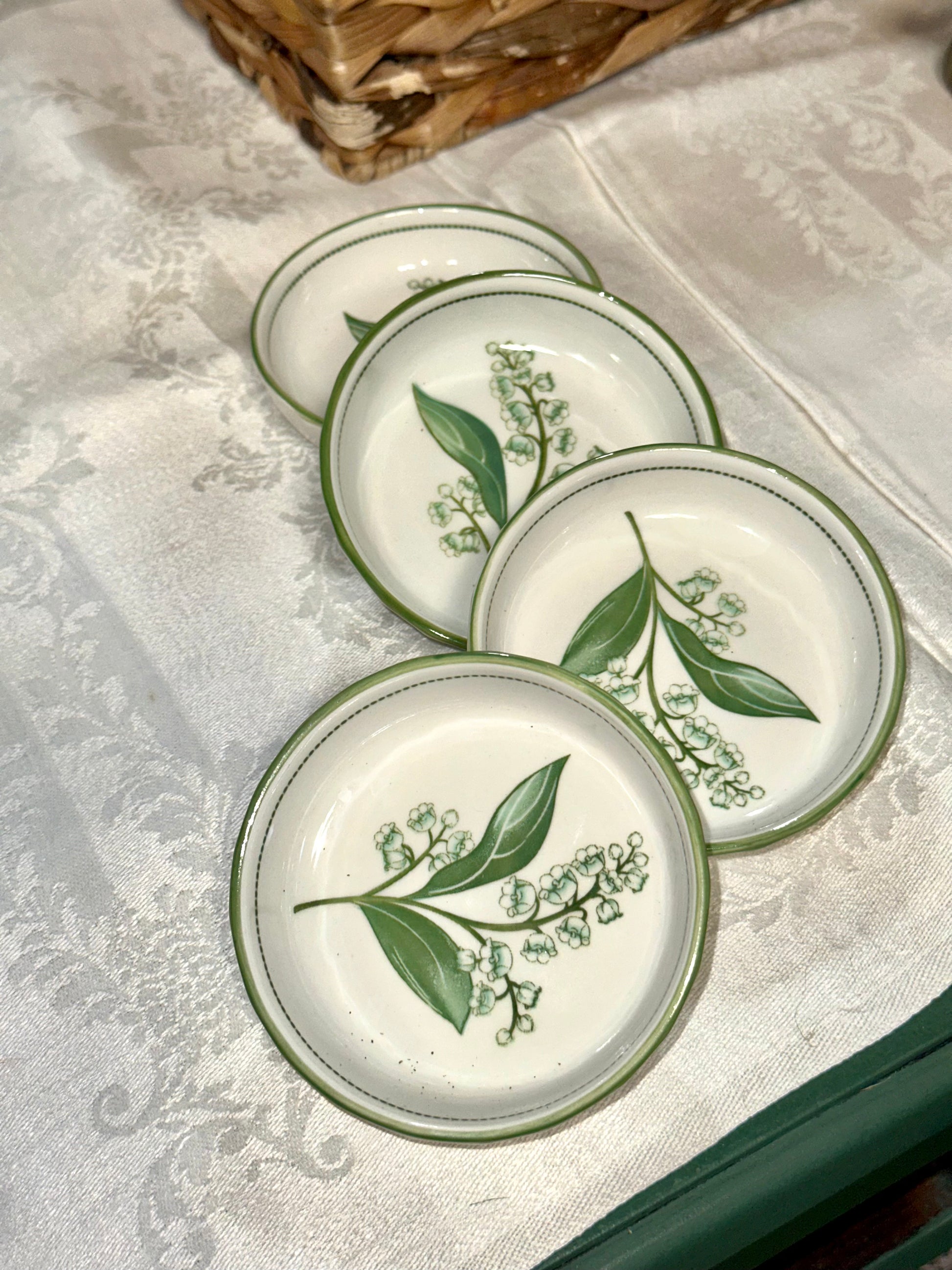 Set of four vintage Lily of the Valley ceramic dessert bowls.