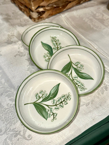 Vintage floral stoneware bowls with green rim and botanical design.