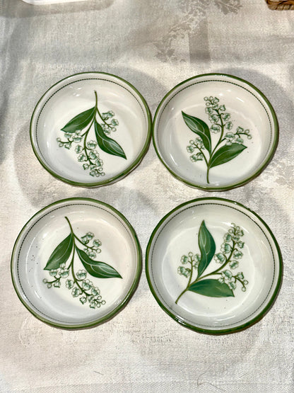 Ceramic cereal bowls featuring Lily of the Valley flowers.