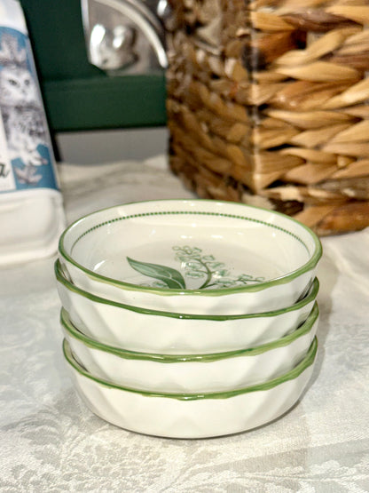 Vintage green-rimmed bowls with white floral pattern.