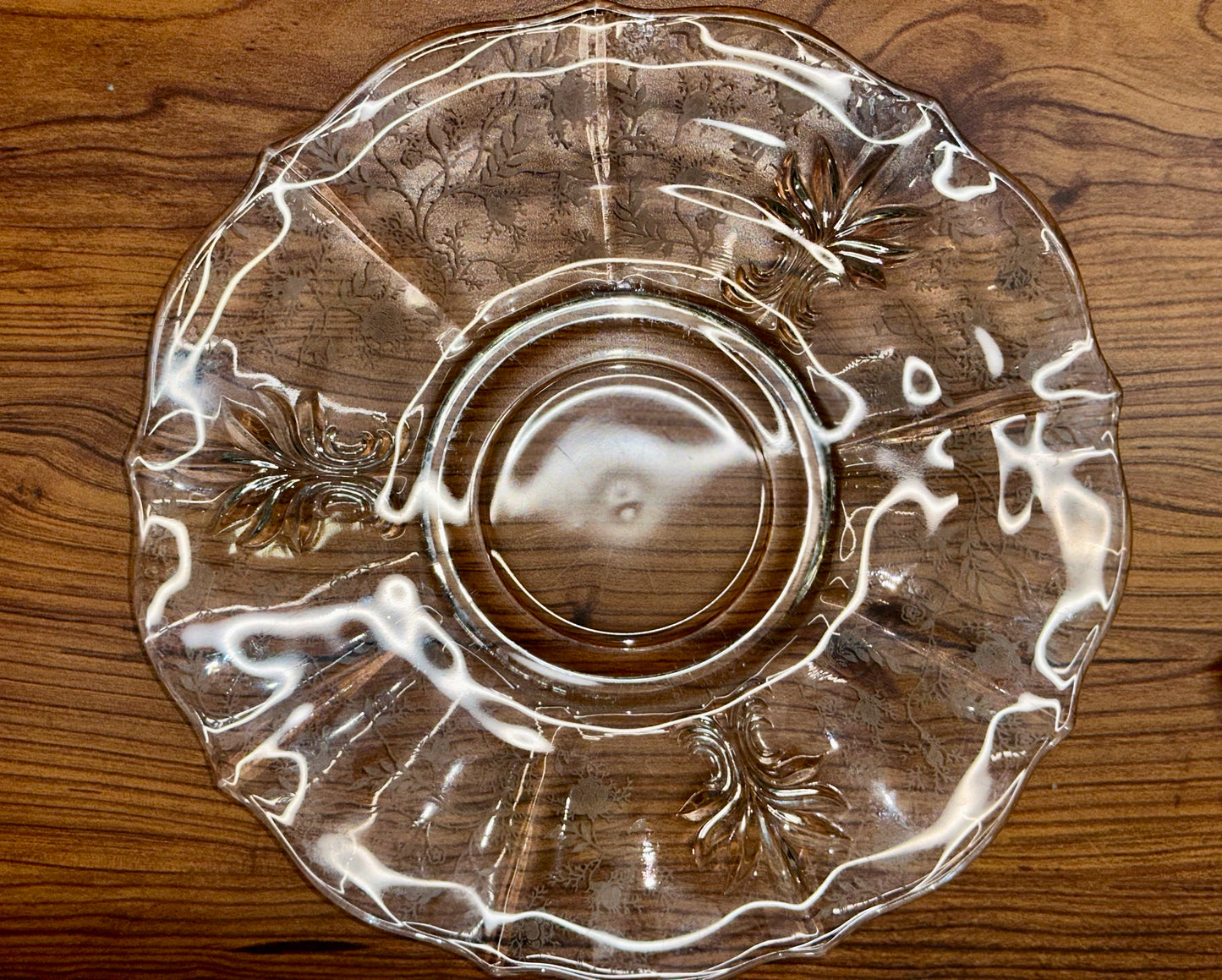 Vintage clear glass serving plate with scalloped edge and decorative scroll design