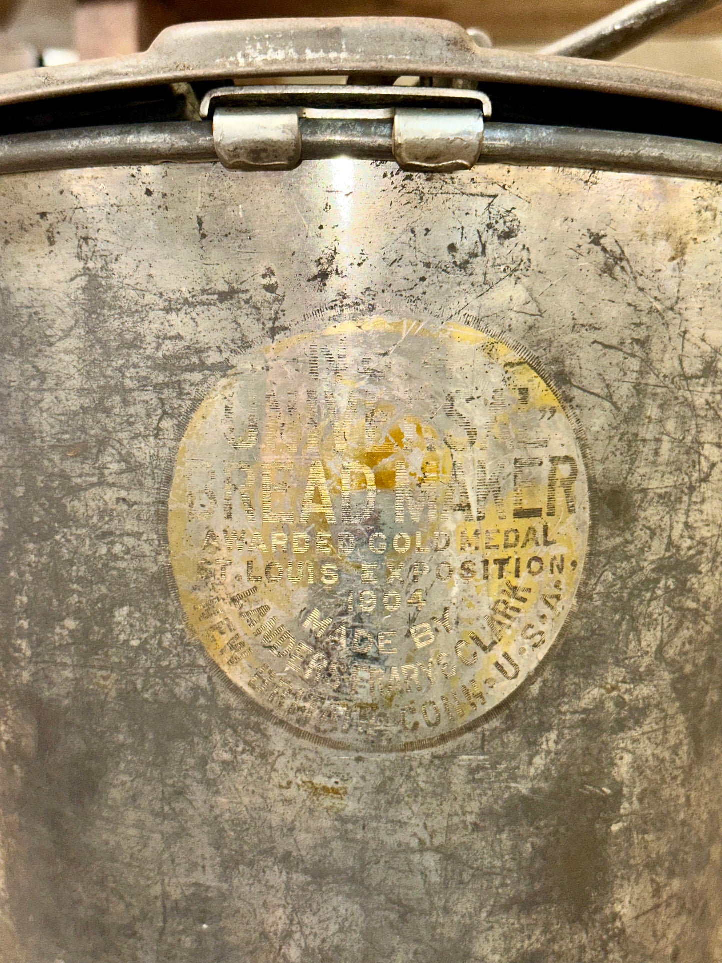 Top view of antique Universal Bread Maker showing original hand crank mechanism and embossed lid