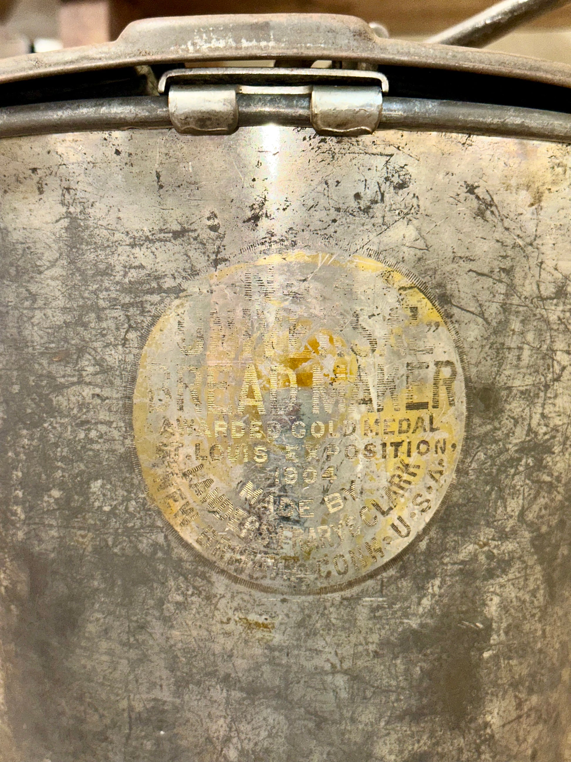 Top view of antique Universal Bread Maker showing original hand crank mechanism and embossed lid