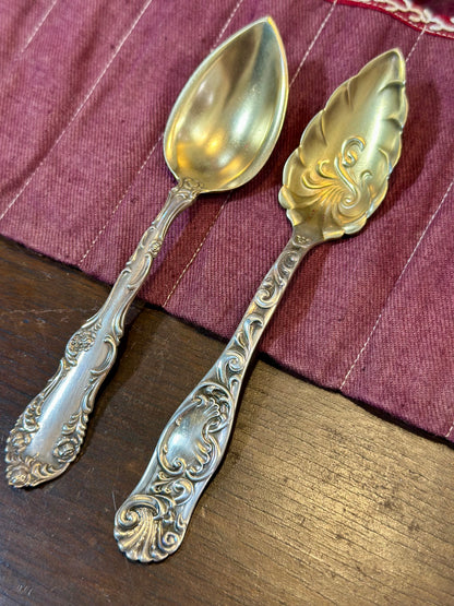 Antique silverplate serving spoons with floral embossed handles