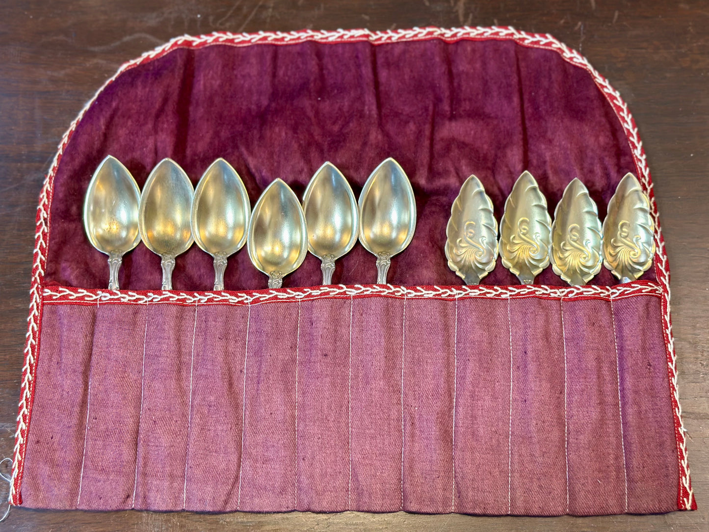Vintage silverplate serving spoon set in purple fabric storage roll